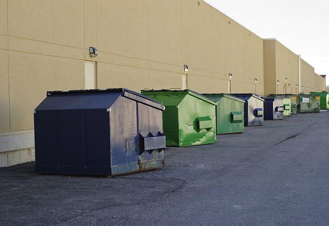 a row of heavy-duty dumpsters ready for use at a construction project in Needham Heights